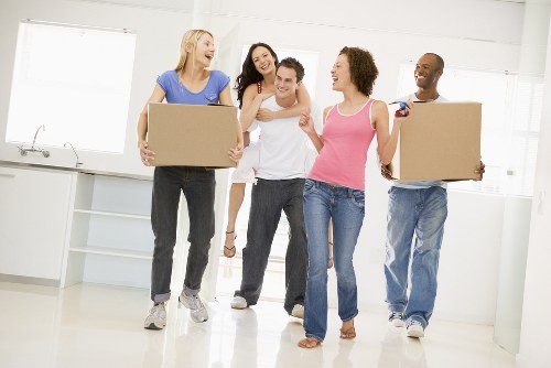 Professional team handling piano removals in Mayfair with protective equipment