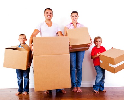 Removal team sorting recyclable packing materials at a London property