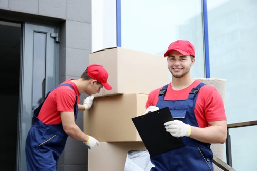 Removal team working carefully during a home move with safety measures in place