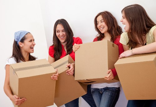 Professional movers carrying boxes in central London