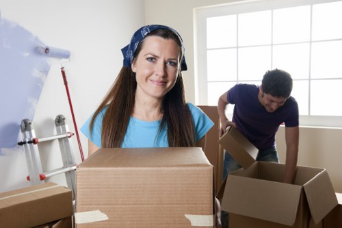 Trained movers handling items with proper lifting technique and equipment