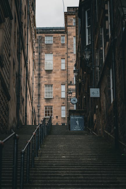 A steep outdoor staircase leading up to a residential building on Mount Street in Mayfair, constructed from stone with metal handrails on both sides. The stairs are lined with protective blankets and