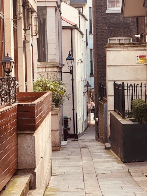 A steep outdoor staircase leading up to a residential building on Mount Street in Mayfair, constructed from stone with metal handrails on both sides. The stairs are lined with protective blankets and